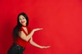 Caucasian young woman`s monochrome portrait on red studio background, emotional and expressive Royalty Free Stock Photo