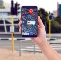 Showing you the way to go. a hand holding a smartphone showing gps data with a street as background. Royalty Free Stock Photo