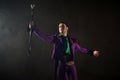 Showman. Young male entertainer, presenter or actor on stage. The guy in the purple camisole and the cylinder. Royalty Free Stock Photo