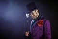 Showman. Young male entertainer, presenter or actor on stage. The guy in the purple camisole and the cylinder. Royalty Free Stock Photo