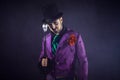 Showman. Young male entertainer, presenter or actor on stage. The guy in the purple camisole and the cylinder. Royalty Free Stock Photo