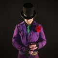 Showman. Young male entertainer, presenter or actor on stage. The guy in the purple camisole and the cylinder. Royalty Free Stock Photo