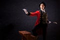 Showman. Young male entertainer, presenter or actor on stage. The guy in the red camisole and the cylinder. Royalty Free Stock Photo