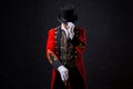 Showman. Young male entertainer, presenter or actor on stage. The guy in the red camisole and the cylinder. Royalty Free Stock Photo