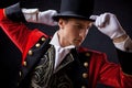 Showman. Young male entertainer, presenter or actor on stage. The guy in the red camisole and the cylinder. Royalty Free Stock Photo