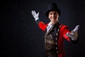 Showman. Young male entertainer, presenter or actor on stage. The guy in the red camisole and the cylinder.