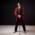 Showman. Young male entertainer, presenter or actor on stage. The guy in the red camisole and the cylinder. Royalty Free Stock Photo