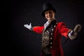 Showman. Young male entertainer, presenter or actor on stage. The guy in the red camisole and the cylinder. Royalty Free Stock Photo