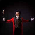 Showman. Young male entertainer, presenter or actor on stage. The guy in the red camisole and the cylinder. Royalty Free Stock Photo