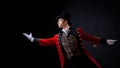 Showman. Young male entertainer, presenter or actor on stage. The guy in the red camisole and the cylinder. Royalty Free Stock Photo