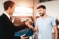 Showroom Dealer The Gives Car Keys To The Buyer.