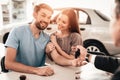 Showroom Dealer The Gives Car Keys To The Buyer.