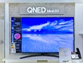 Showroom of modern electronics with new generation large TV-sets with technology QNED