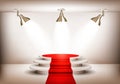 Showroom with red carpet leading to a podium and three lights. Royalty Free Stock Photo