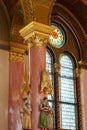 Interior hall with sculpted statues and stained glass in Parliament House, Budapest, Hungary; Painted and decorated in gold leaf.