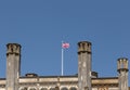 Shows a Union Jack flag flying on top of a castle roof Royalty Free Stock Photo