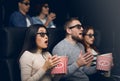 Bewildered people scared of 3D thriller in movie theater Royalty Free Stock Photo