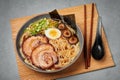 A Shoyu Ramen in gray bowl on concrete table top. Japanese cuisine meat noodle soup with chashu pork. Asian food Royalty Free Stock Photo