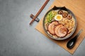 A Shoyu Ramen in gray bowl on concrete table top. Japanese cuisine meat noodle soup with chashu pork. Asian food Royalty Free Stock Photo