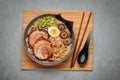 A Shoyu Ramen in gray bowl on concrete table top. Japanese cuisine meat noodle soup with chashu pork. Asian food Royalty Free Stock Photo