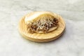 Shredded beef arepa with traditional Venezuelan cheese on white marble table