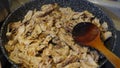 shredded chicken meat in frying pan, frying chicken meat in oil