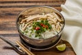 Shredded Chicken and Sausage Pho topping with noodles, spring onion, red chilli, coriander and chopsticks served in bowl isolated Royalty Free Stock Photo