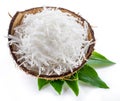 Shredded coconut flakes in the coconut shell isolated on white background Royalty Free Stock Photo