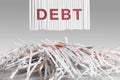 Shredded red DEBT letters above Cut up credit cards on Shredded Bills and Bank Statements Royalty Free Stock Photo