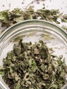 Shredded dried mint in a glass jar. Closeup view
