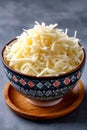 Shredded mozzarella cheese in a ceramic bowl Royalty Free Stock Photo