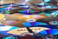 Shredded optical compact disc parts on heap of colored archiving media Royalty Free Stock Photo