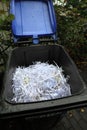 Shredded paper after shredding in a blue bin Royalty Free Stock Photo