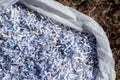 Shredded paper in a white plastic trash bag Royalty Free Stock Photo