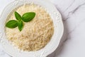 Shredded parmesan on a plate closeup. Plate of grated grana padano cheese over marble background. Italian hard cheese prepared for Royalty Free Stock Photo