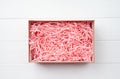 Shredded pink paper packing material texture in a craft box, mockup design Royalty Free Stock Photo