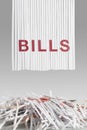 Shredded red BILLS letters above Cut up credit cards on Shredded Bills and Bank Statements Royalty Free Stock Photo