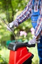 Shredding branches with an electric garden shredder Royalty Free Stock Photo