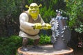Shrek character turning a chainwheel of old hand water pump Royalty Free Stock Photo