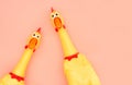 Shrilling Chicken toy on a pastel pink background. Rubber squeaky Chicken Toys are isolated on a coral background. Copyspace