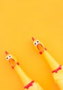 Shrilling Chicken toy on a yellow background. Rubber squeaky Chicken Toys are isolated on a orange background. Copyspace