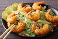 Shrimp in breadcrumbs with green pasta, chili pepper and sesame Royalty Free Stock Photo