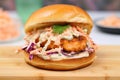 shrimp burger on brioche bun with spiced mayo and coleslaw Royalty Free Stock Photo
