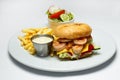 Shrimp burger with caviar, vegetable salad and french fries, shrimp sauce Royalty Free Stock Photo