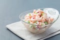 Shrimp, celery and red onion salad in glass bowl, horizontal, copy space