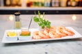 shrimp cocktail platter with dipping sauce and parsley