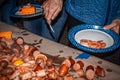 Shrimp and Crawdad boil - food piled on paper taped to table and people in line picking out what they want - paper plates