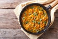 Shrimp in curry sauce in the pan. horizontal top view Royalty Free Stock Photo