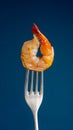 Shrimp on fork on blue