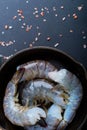 Raw shrimp in a frying pan top view on a black background Royalty Free Stock Photo